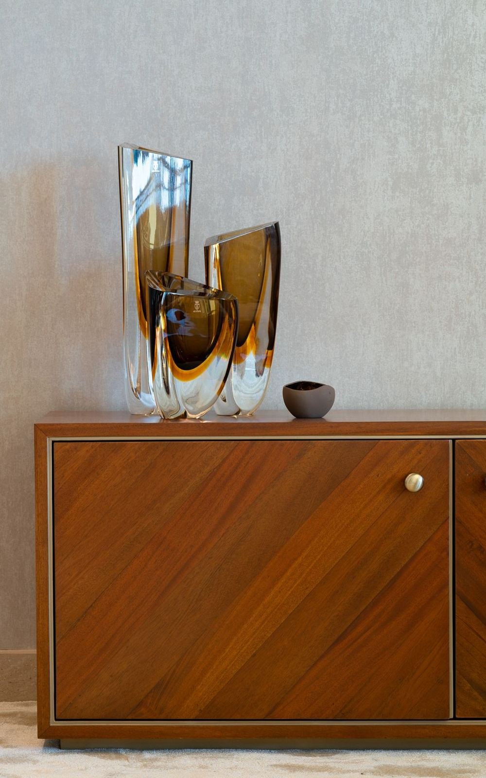 Walnut-veneer cabinet detail with fine bronze inlay