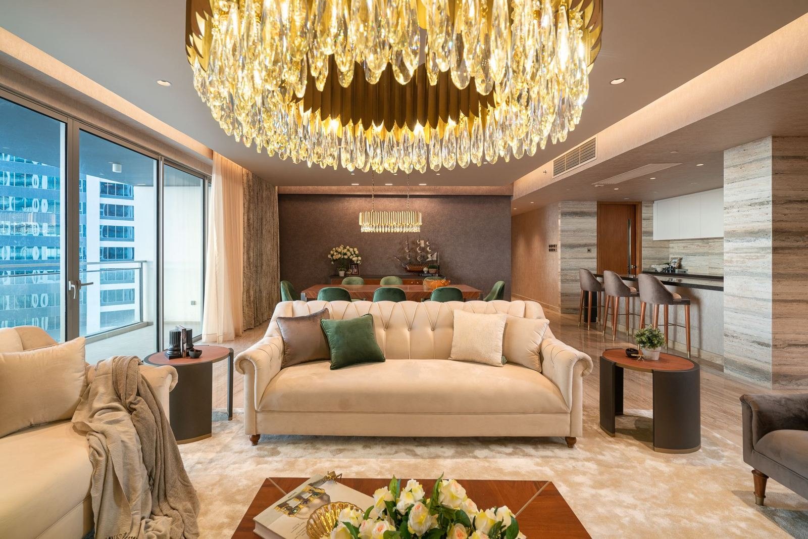 Living room with travertine-toned wall cladding and full-height sheers