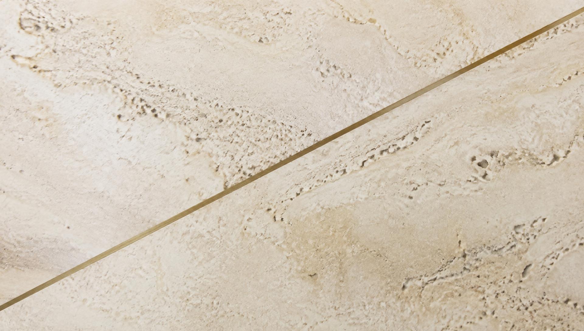 Honed travertine with a fine brass inlay